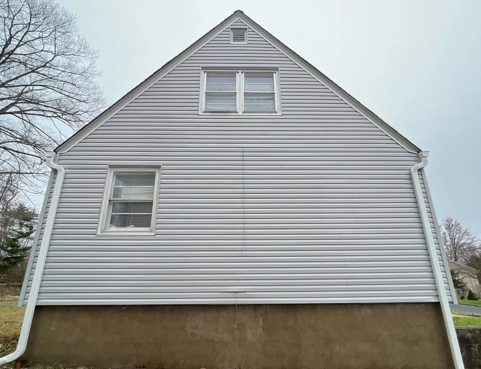 Hudson Power Washing technician performing detailed house washing in Hudson residential area